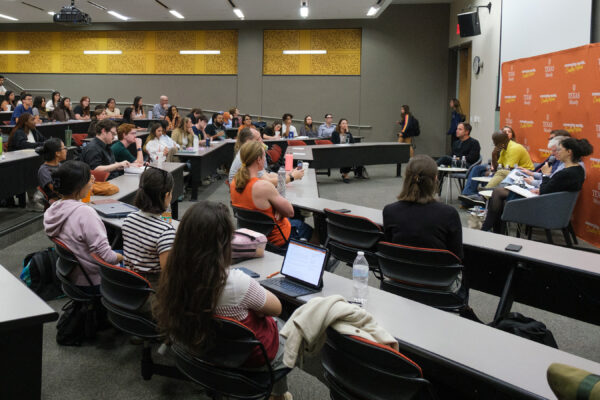 Auditorium of people watching a panel discussion